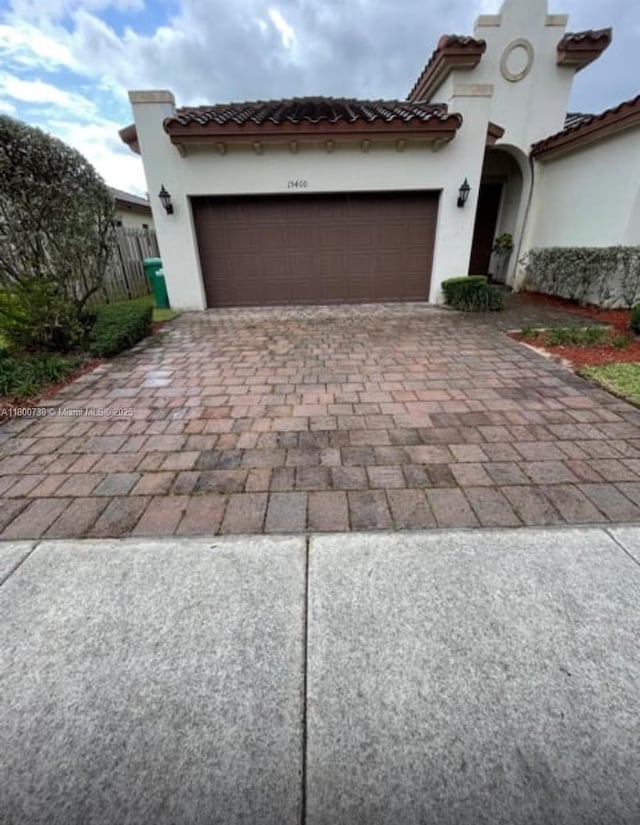 15400 SW 176th Ln, Miami, FL 33187 - view of front of home with decorative driveway, stucco siding, a garage, and a tiled roof