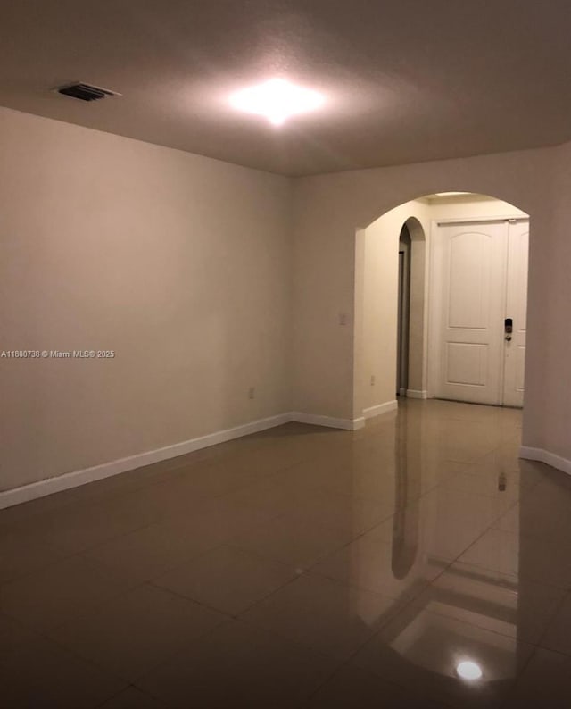 15400 SW 176th Ln, Miami, FL 33187 - spare room with arched walkways, baseboards, and tile patterned flooring