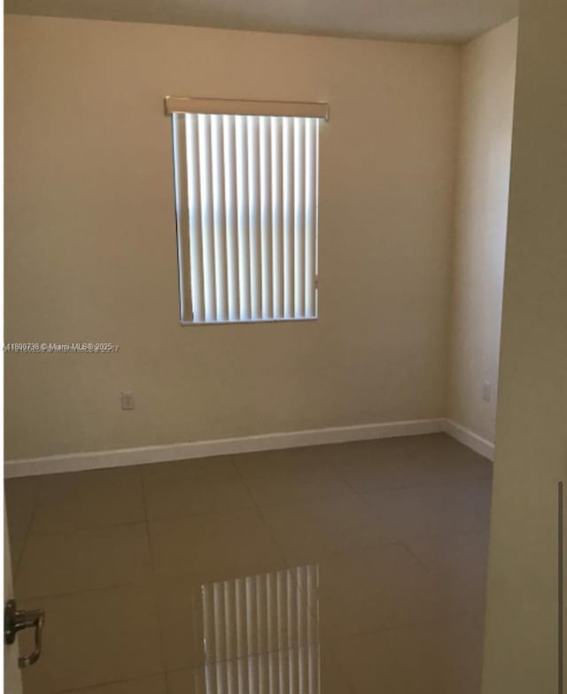 15400 SW 176th Ln, Miami, FL 33187 - empty room featuring tile patterned floors and baseboards