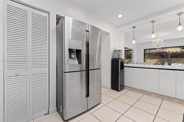 1032 NE 204th Ln Unit B, Miami, FL 33179 - kitchen featuring stainless steel refrigerator with ice dispenser, white cabinetry, a chandelier, pendant lighting, and light tile patterned floors