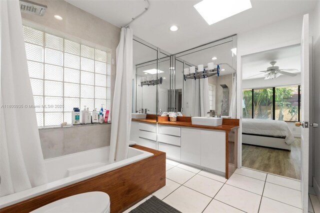 1032 NE 204th Ln Unit B, Miami, FL 33179 - ensuite bathroom featuring tile patterned floors, toilet, double vanity, shower / bath combo with shower curtain, and recessed lighting