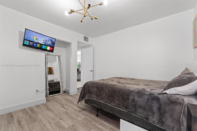 1032 NE 204th Ln Unit B, Miami, FL 33179 - bedroom featuring wood finished floors, a chandelier, and baseboards