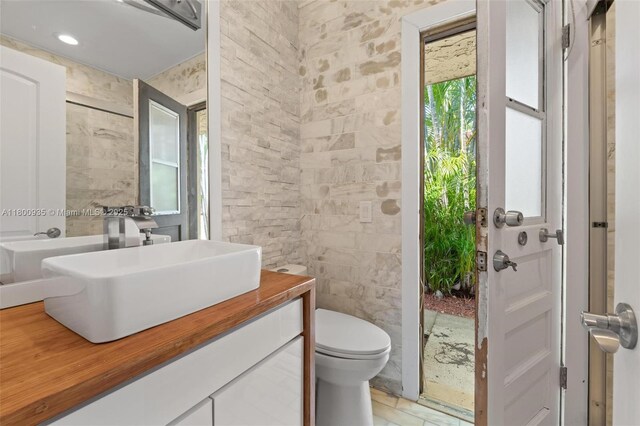 1032 NE 204th Ln Unit B, Miami, FL 33179 - bathroom featuring toilet, vanity, and tile walls