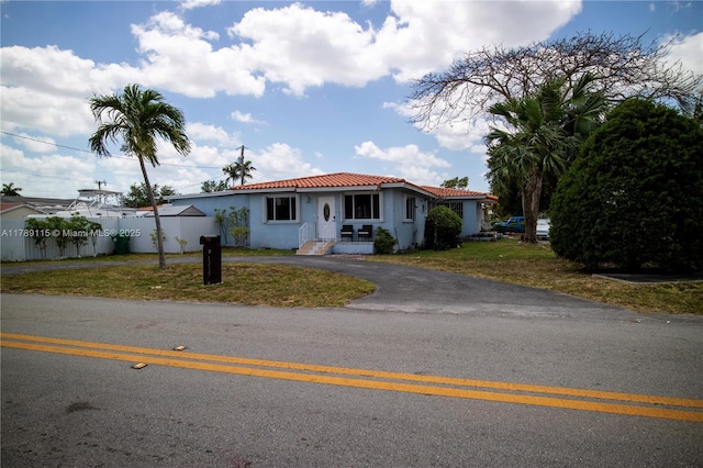 1205 SW 76th Ave, Miami, FL 33144 - mediterranean / spanish house featuring stucco siding, driveway, and a tile roof