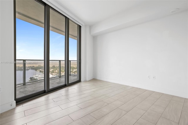 2000 Metropica Way Unit 2504, Sunrise, FL 33323 - empty room with floor to ceiling windows and a water view