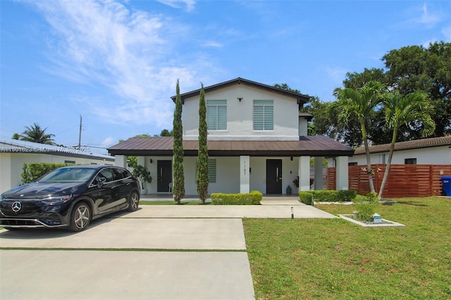 1187 NE 182nd St, North Miami Beach, FL 33162 - view of front of property featuring stucco siding, covered porch, metal roof, driveway, and a standing seam roof