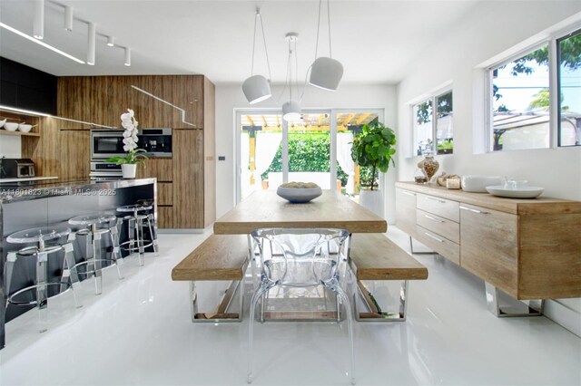 1187 NE 182nd St, North Miami Beach, FL 33162 - dining area featuring healthy amount of natural light and track lighting
