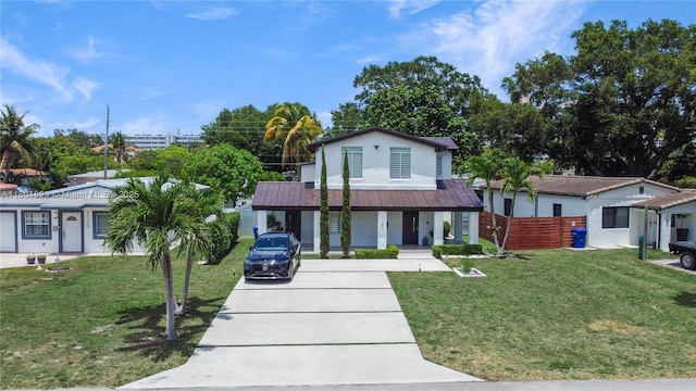 1187 NE 182nd St, North Miami Beach, FL 33162 - view of front facade with concrete driveway, stucco siding, and covered porch