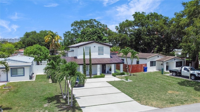 1187 NE 182nd St, North Miami Beach, FL 33162 - view of front of house with stucco siding, concrete driveway, and covered porch