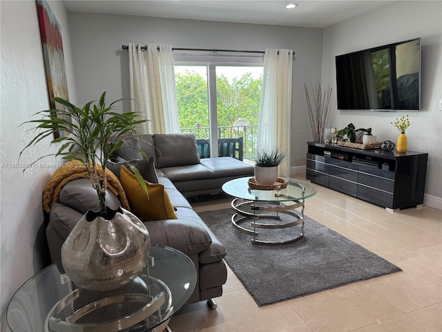 tiled living area with recessed lighting and baseboards