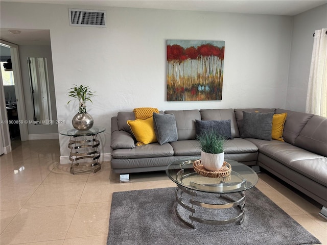 living room featuring baseboards and tile patterned floors