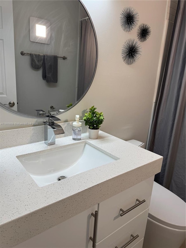 bathroom featuring toilet and vanity
