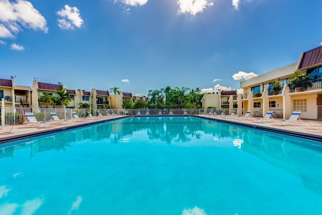 community pool featuring fence and a patio