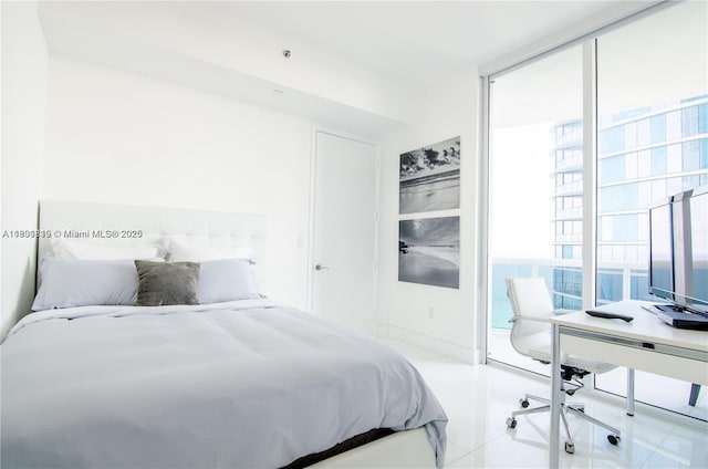 15811 Collins Ave Unit 2602, Sunny Isles Beach, FL 33160 - tiled bedroom featuring multiple windows, a desk, and floor to ceiling windows