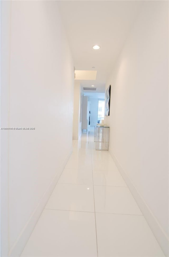 15811 Collins Ave Unit 2602, Sunny Isles Beach, FL 33160 - hallway featuring light tile patterned floors, recessed lighting, and baseboards