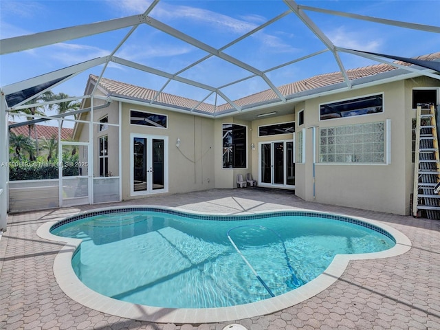 4985 NW 120th Ave, Coral Springs, FL 33076 - back of property with french doors, stucco siding, a patio area, an outdoor pool, and a tiled roof