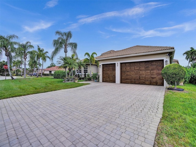 4985 NW 120th Ave, Coral Springs, FL 33076 - view of front facade featuring decorative driveway, an attached garage, a front lawn, a tile roof, and stucco siding