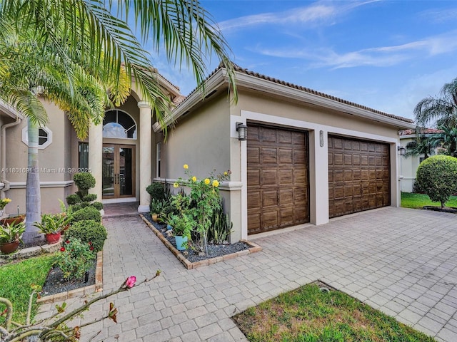 4985 NW 120th Ave, Coral Springs, FL 33076 - garage featuring french doors and decorative driveway