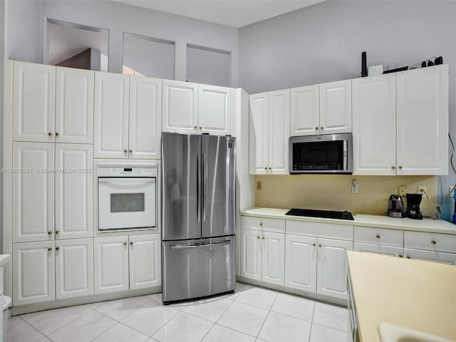 4985 NW 120th Ave, Coral Springs, FL 33076 - kitchen featuring stainless steel appliances, light countertops, white cabinets, and light tile patterned flooring