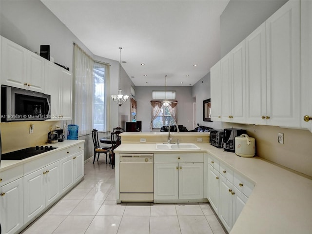 4985 NW 120th Ave, Coral Springs, FL 33076 - kitchen featuring dishwasher, stainless steel microwave, a sink, black electric stovetop, and a peninsula