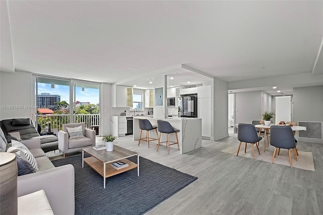 137 Golden Isles Dr Unit 305, Hallandale Beach, FL 33009 - living area featuring light wood-type flooring and recessed lighting