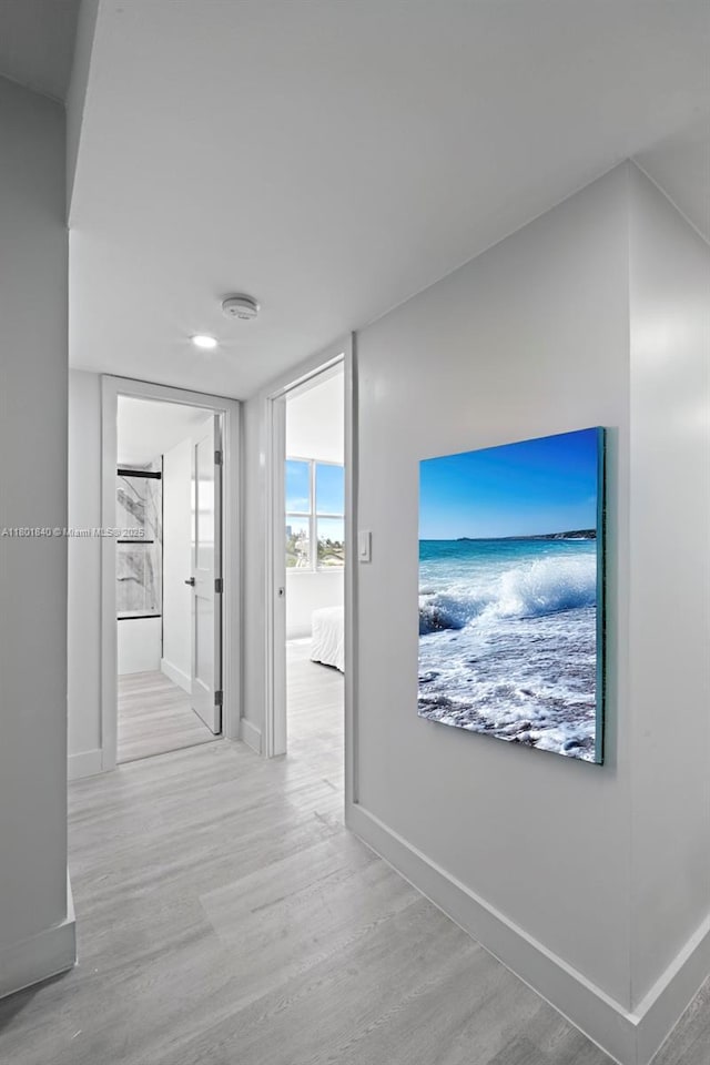 137 Golden Isles Dr Unit 305, Hallandale Beach, FL 33009 - hallway with wood finished floors, baseboards, and a water view