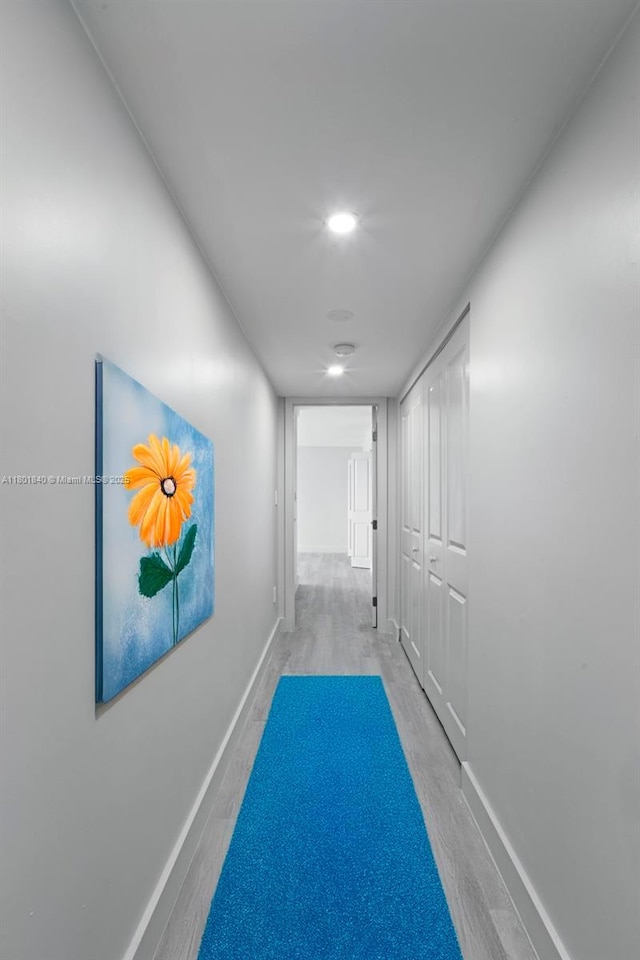 137 Golden Isles Dr Unit 305, Hallandale Beach, FL 33009 - hallway featuring wood finished floors, baseboards, and recessed lighting