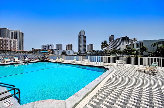 137 Golden Isles Dr Unit 305, Hallandale Beach, FL 33009 - community pool with fence and a view of city