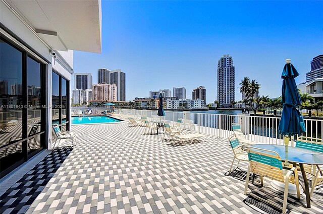 137 Golden Isles Dr Unit 305, Hallandale Beach, FL 33009 - community pool featuring outdoor dining space, a view of city, and a water view