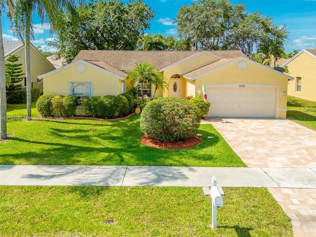 ranch-style house with an attached garage, a front lawn, and stucco siding