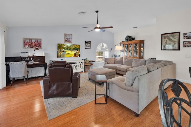 living room with light wood-style floors, ceiling fan, and vaulted ceiling