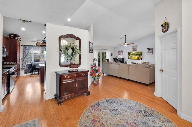 kitchen featuring a ceiling fan, light wood-style floors, stainless steel range with electric stovetop, lofted ceiling, and recessed lighting