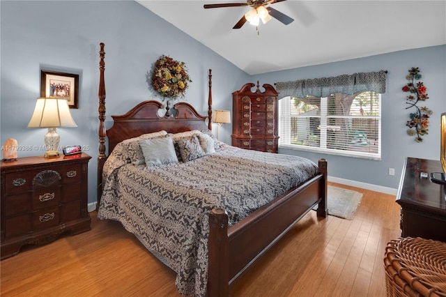 bedroom featuring lofted ceiling, baseboards, wood finished floors, and ceiling fan