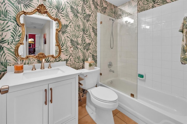 full bathroom with wallpapered walls, toilet, tile patterned floors, vanity, and washtub / shower combination