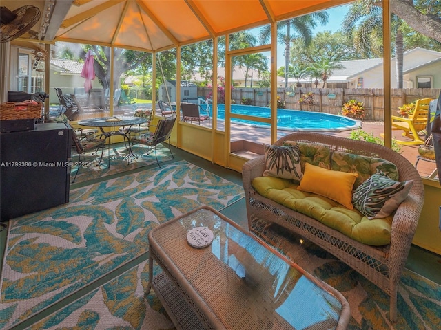 sunroom with vaulted ceiling, outdoor dining area, and an outdoor hangout area