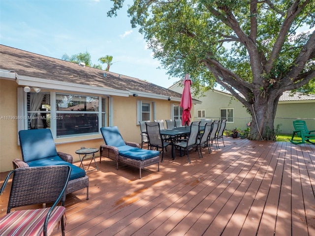 wooden terrace featuring outdoor dining area