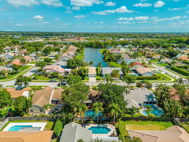 aerial view of residential area with a pool area and a nearby body of water