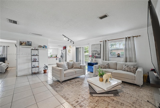 6400 Sheridan St, Hollywood, FL 33024 - living area featuring light tile patterned flooring, a textured ceiling, and track lighting