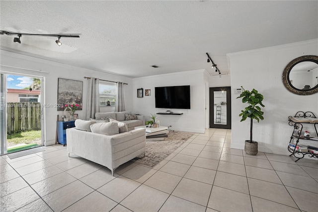 6400 Sheridan St, Hollywood, FL 33024 - living area featuring rail lighting, light tile patterned floors, crown molding, a textured ceiling, and baseboards