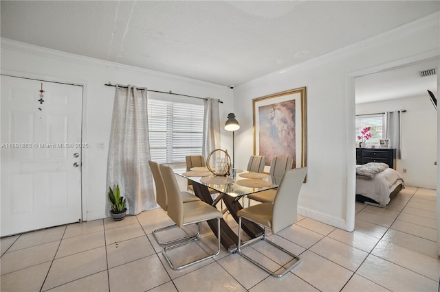 6400 Sheridan St, Hollywood, FL 33024 - dining room with light tile patterned floors, crown molding, and baseboards