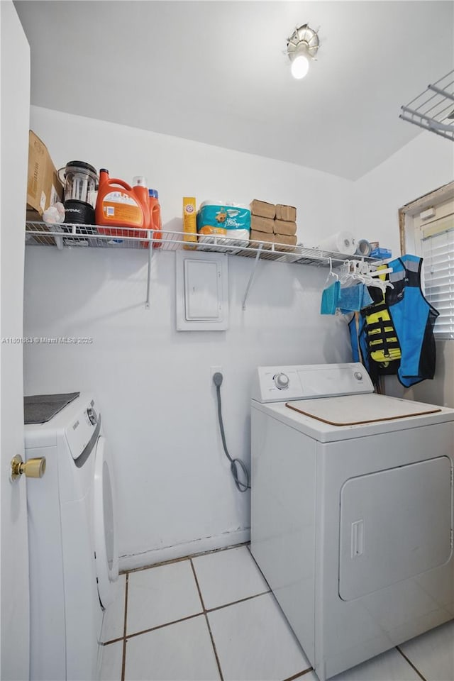 6400 Sheridan St, Hollywood, FL 33024 - clothes washing area featuring independent washer and dryer, light tile patterned floors, and electric panel