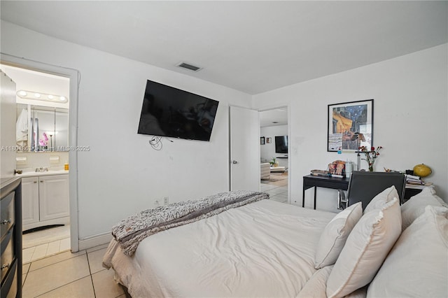 6400 Sheridan St, Hollywood, FL 33024 - bedroom featuring light tile patterned floors, ensuite bath, and a sink