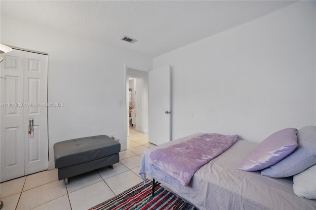 6400 Sheridan St, Hollywood, FL 33024 - bedroom with light tile patterned flooring, a textured ceiling, and a closet