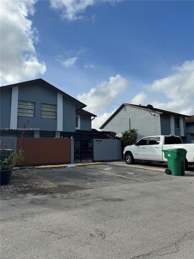 8098 NW 99th Ter, Hialeah Gardens, FL 33016 - view of property exterior with uncovered parking and fence
