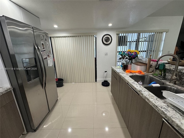8098 NW 99th Ter, Hialeah Gardens, FL 33016 - kitchen featuring stainless steel refrigerator with ice dispenser, a sink, light tile patterned flooring, modern cabinets, and recessed lighting