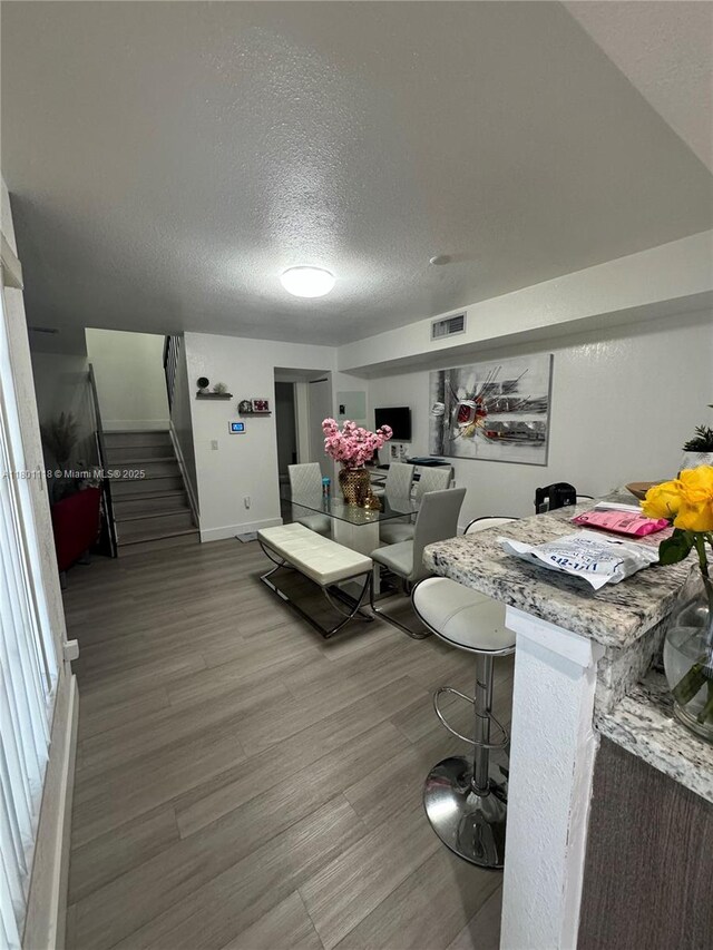 8098 NW 99th Ter, Hialeah Gardens, FL 33016 - living room with stairway, wood finished floors, a textured ceiling, and baseboards