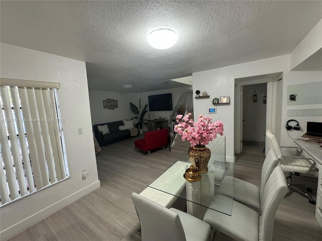 8098 NW 99th Ter, Hialeah Gardens, FL 33016 - dining room with wood finished floors, a textured ceiling, and baseboards