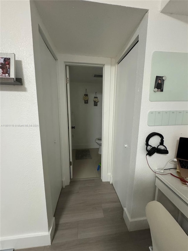8098 NW 99th Ter, Hialeah Gardens, FL 33016 - hallway featuring wood finished floors and baseboards