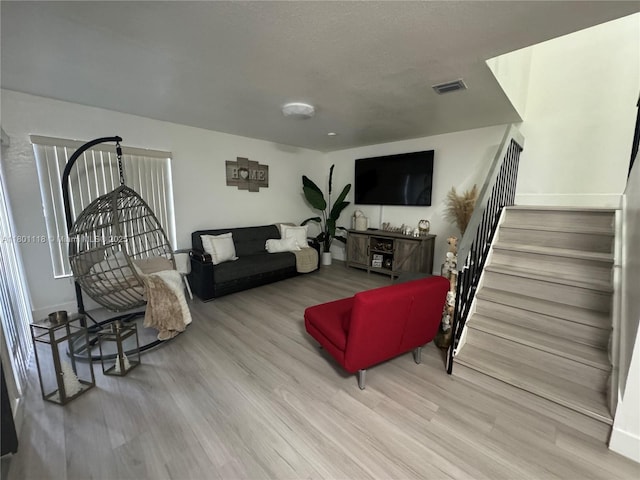 8098 NW 99th Ter, Hialeah Gardens, FL 33016 - living room featuring stairway, wood finished floors, and baseboards