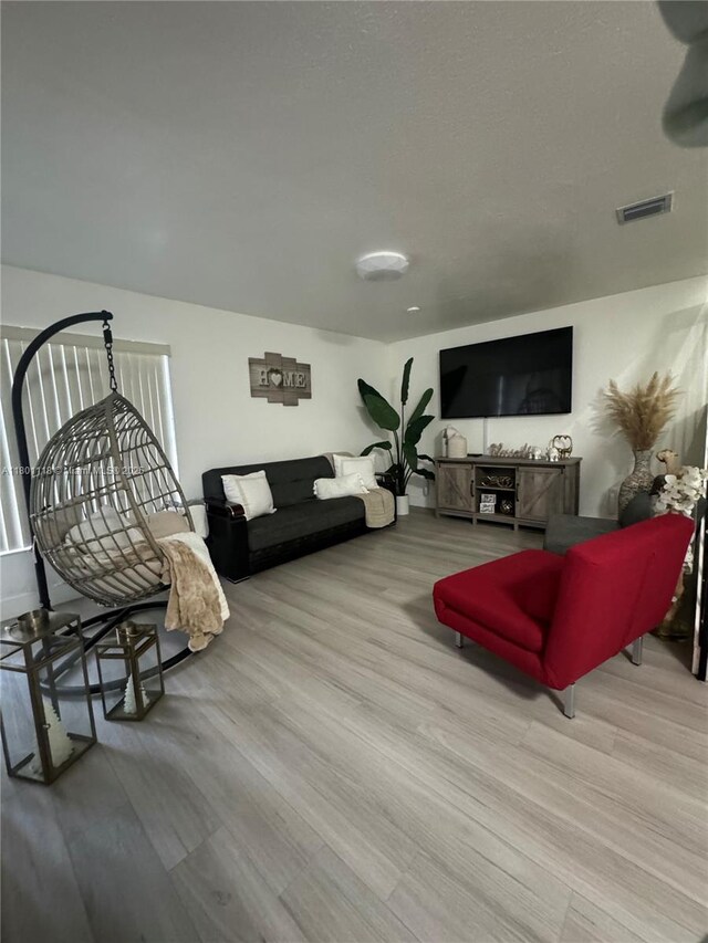 8098 NW 99th Ter, Hialeah Gardens, FL 33016 - living room featuring wood finished floors